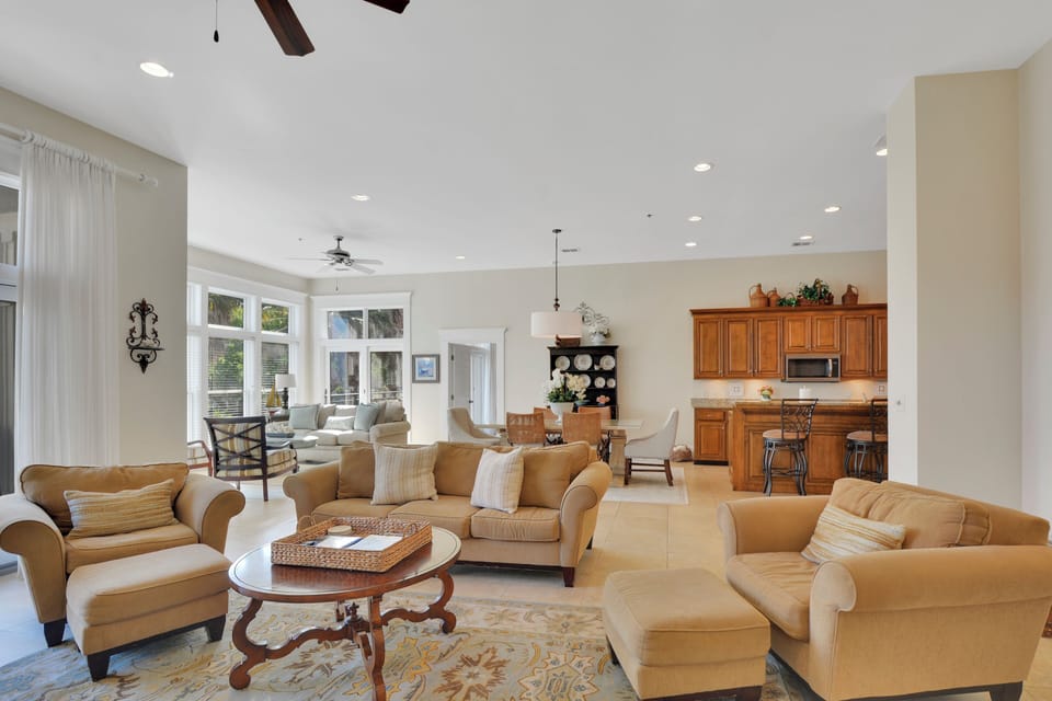 Open Living and Dining Area - Main room connects seating, dining, kitchen, and balcony access for an easy St. Simons condo layout.
