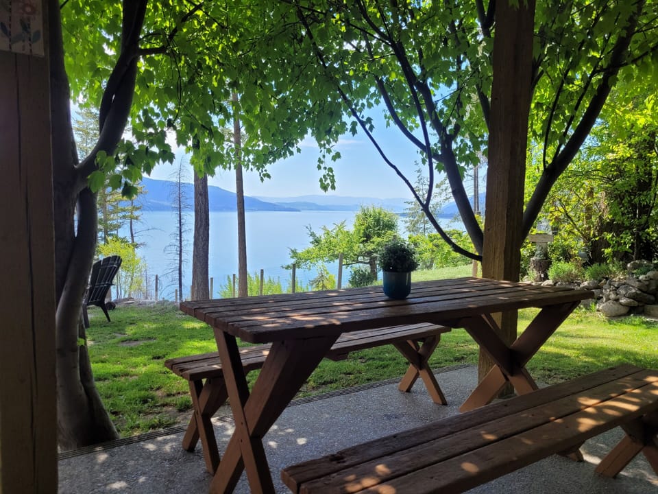 Outdoor picnic table with a view of Okanagan Lake.