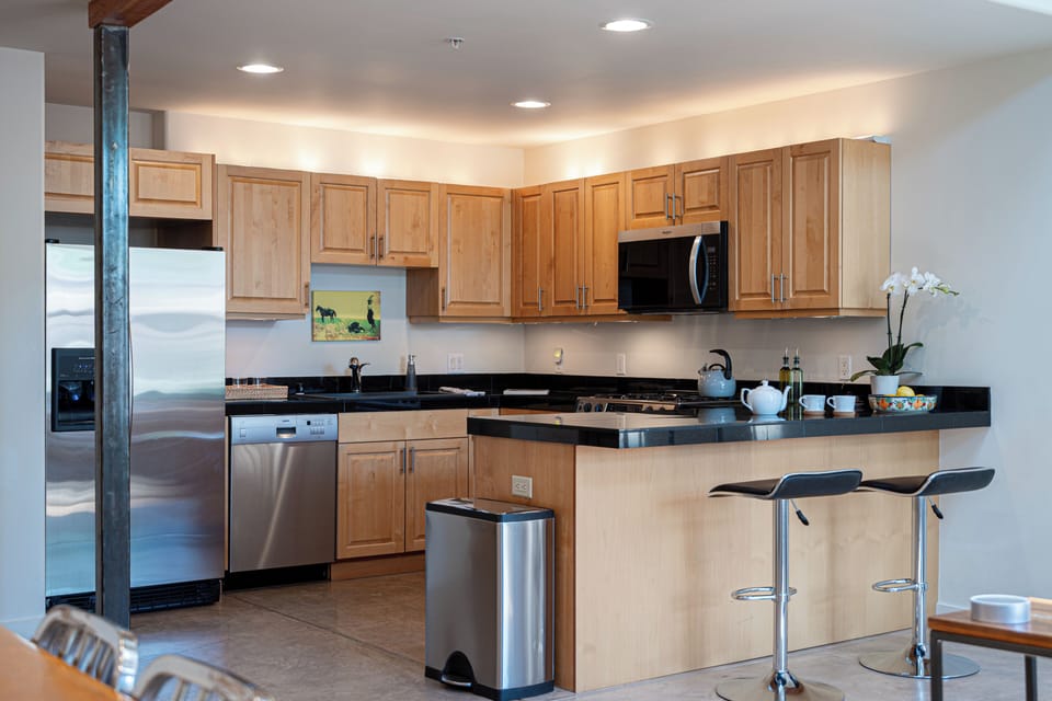 Kitchen with Breakfast Bar - Kitchen featuring a breakfast bar, ample counter space, and a connected dining area.