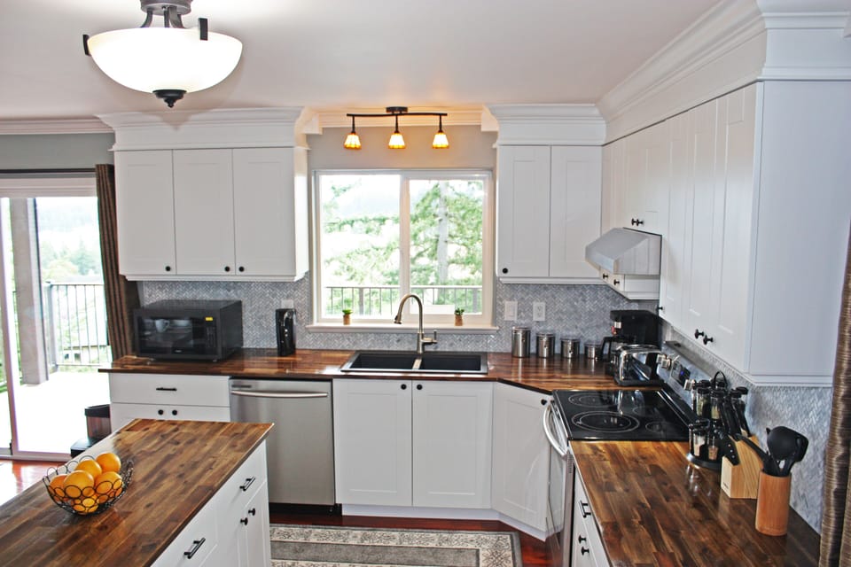 Fully equipped kitchen with stainless steel appliances.