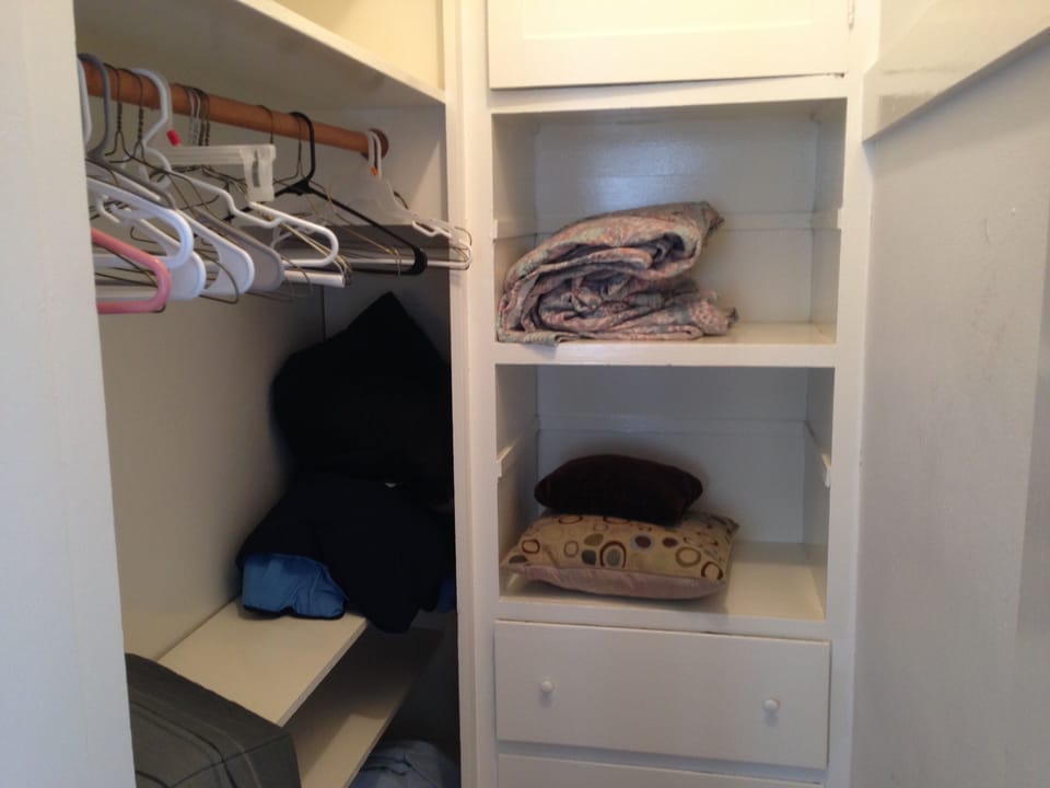huge walk in closet with extra linens and plenty of hangars