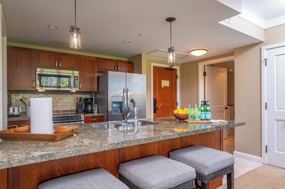 Fully equipped kitchen with bar seating and pendant lighting for both style and function.