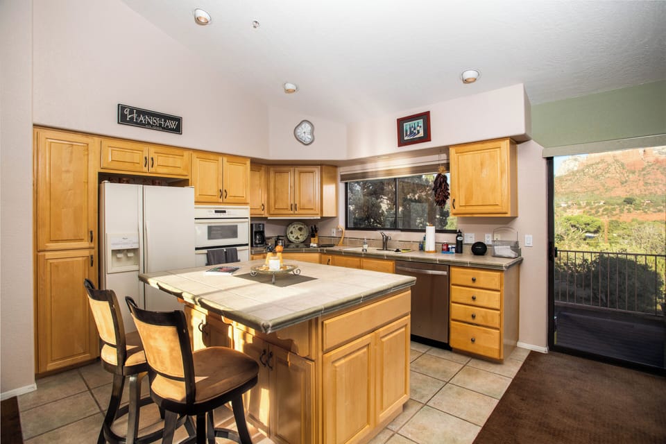 Open concept kitchen with access to wrap around deck with ample red rock views!