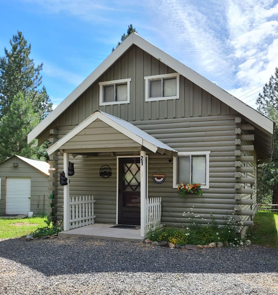 Front of cabin in the summer, with lots of parking.