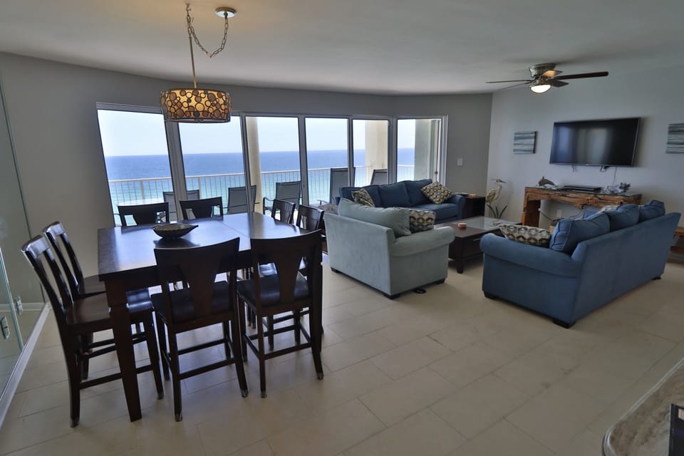 Large dining table and open living room. Enjoy dinner or a movie with a view.