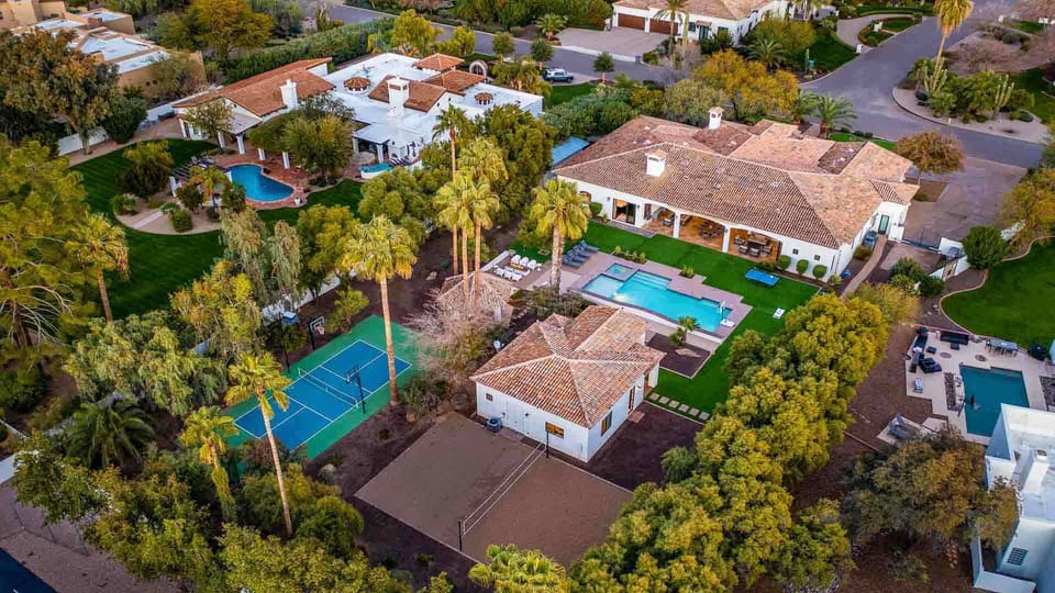 Luxury estate with a resort-style pool, tennis court, and lush private oasis.