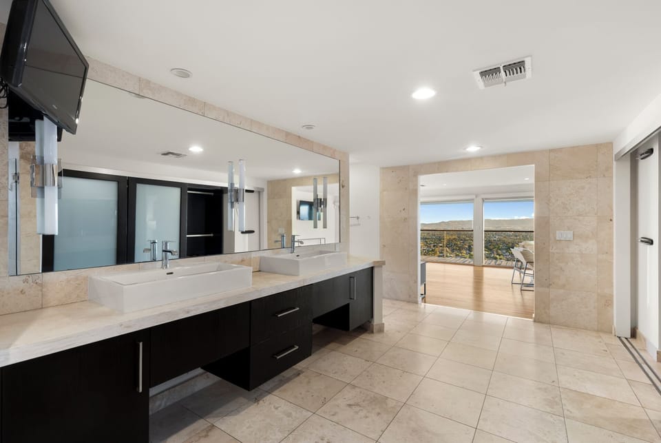 Spa bath: soaking tub, dual vanity, Camelback views.
