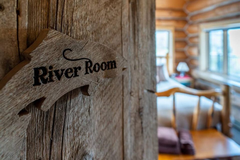 The RIver Room on the main level - private room with access to the outside deck and windows of the river and mountains on three sides.