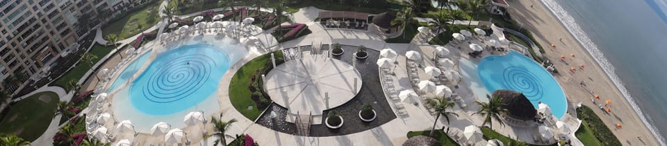 View of pools and beach from patio