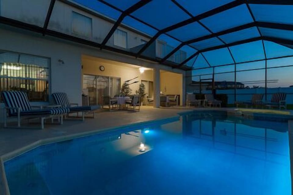 Nightime changing coloured light in pool.