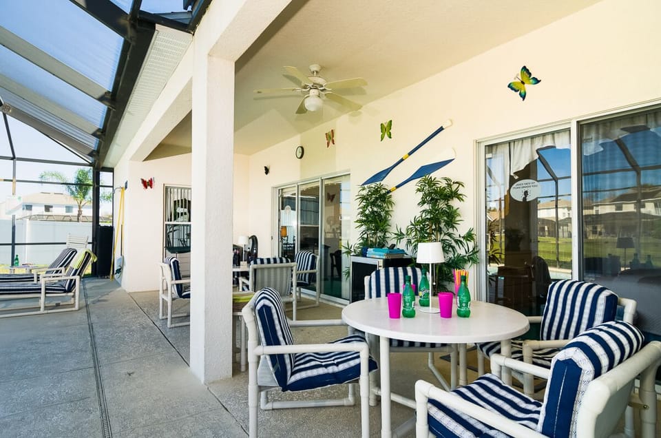 Al fresco dining at its best under a long lanai having a fan night time lighting 