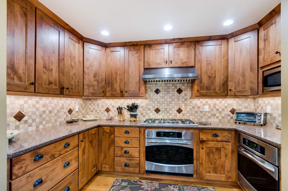 Kitchen with five burner cooktop, two convect ovens.
