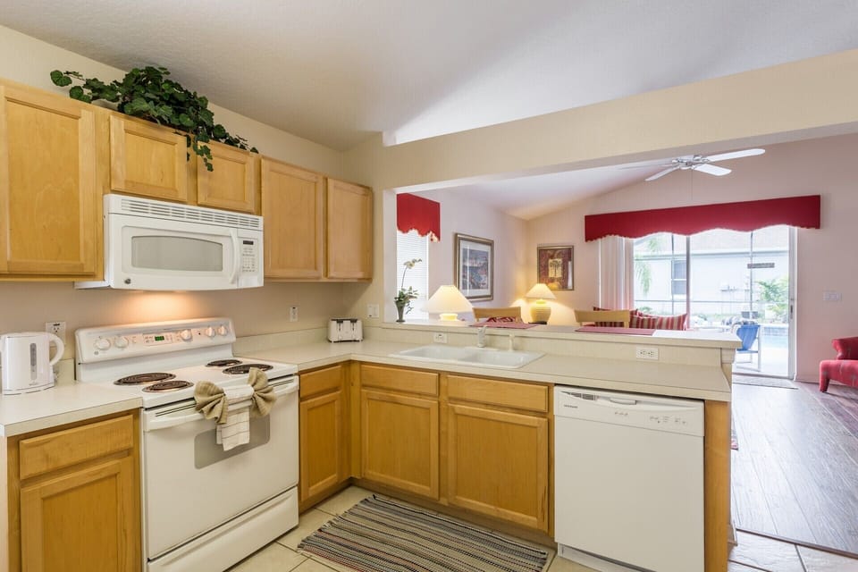 Kitchen with view on the living room and outside patio and pool