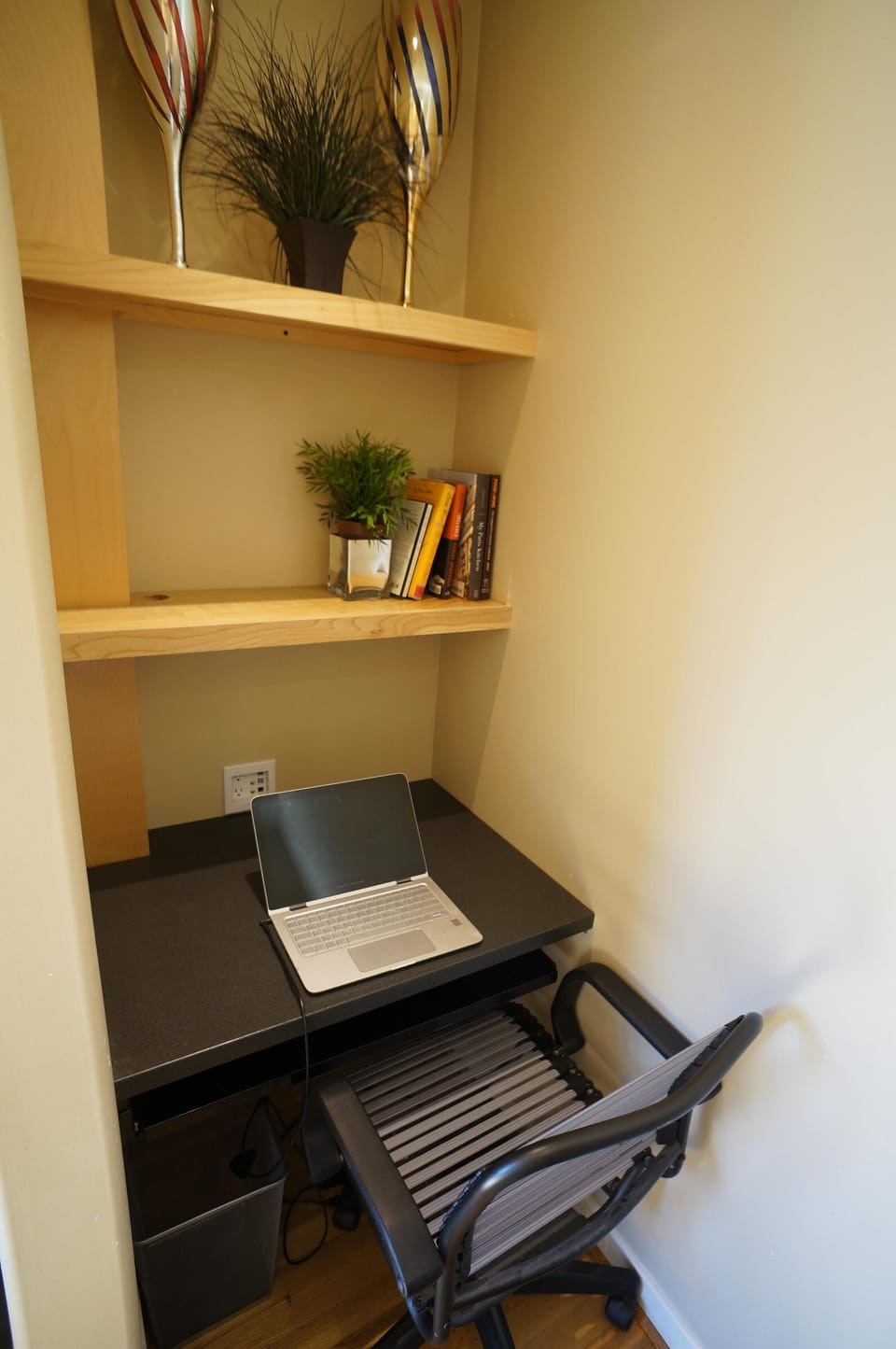 Working nook in living room is stocked with office supplies. 