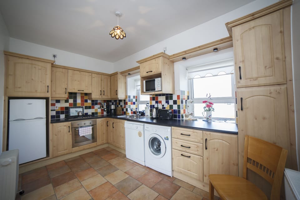 Bright, well equipped kitchen has everything you need for home cooking