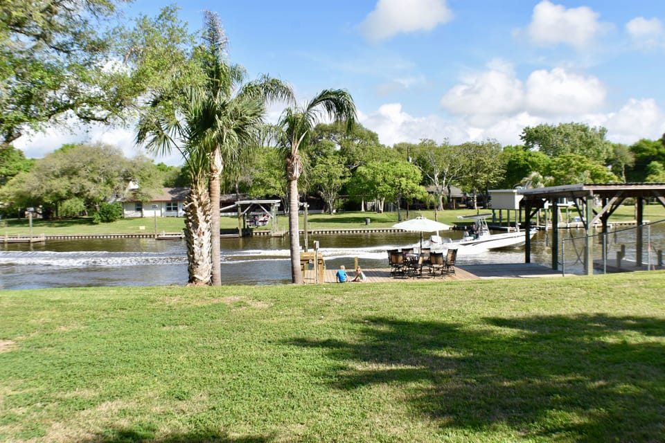View of the creek and private dock from back porch.  Huge backyard!