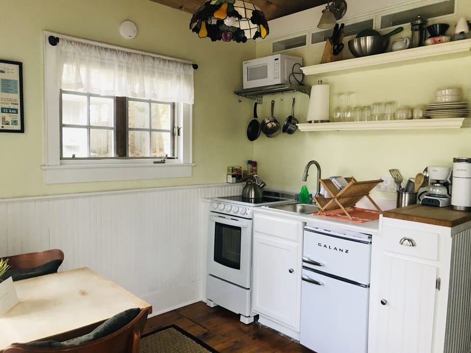 Full kitchen with stove, fridge, microwave
