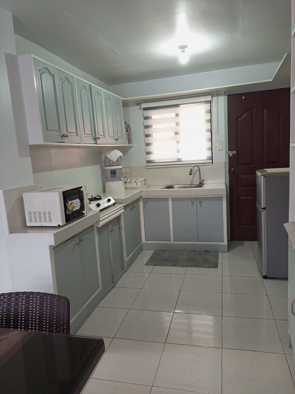 Fully equipped kitchen: fridge, microwave, stove, water dispenser, coffee maker.