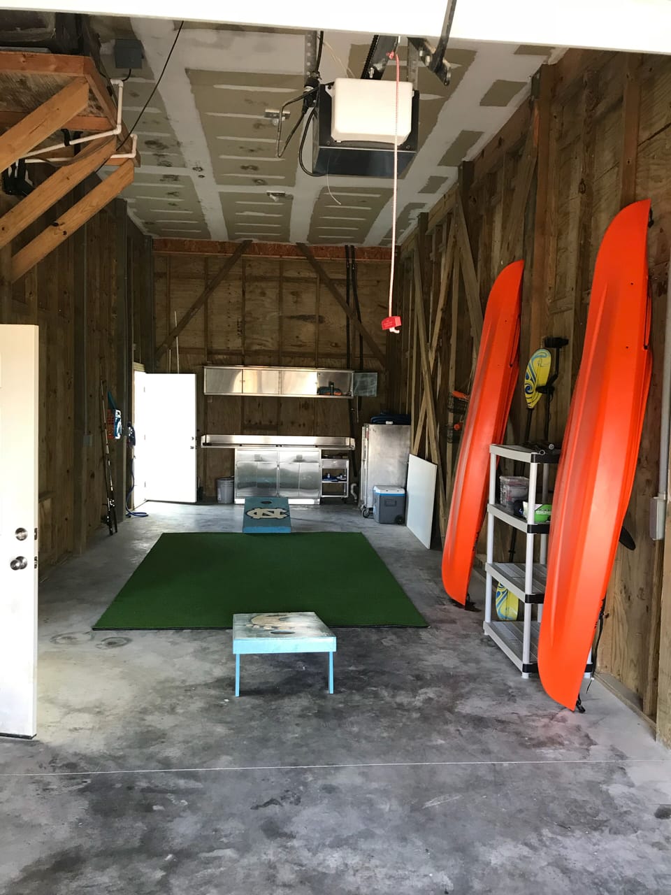 Garage space with kayak, Ping pong table,  and corn hole