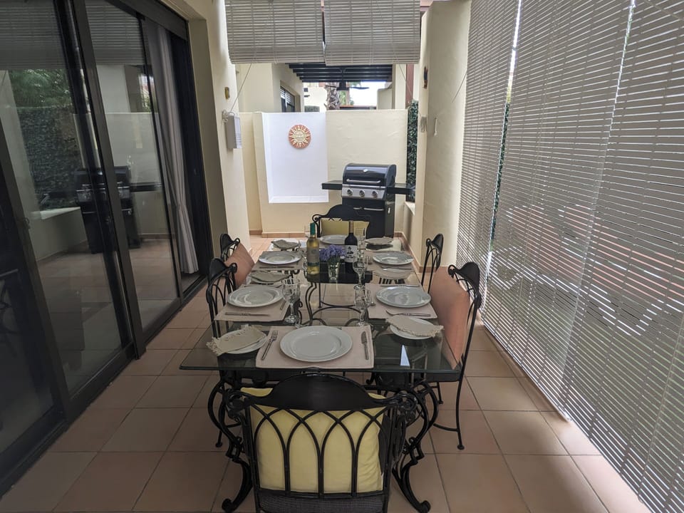 alfresco dining on covered patio. air cooled with wooden blinds