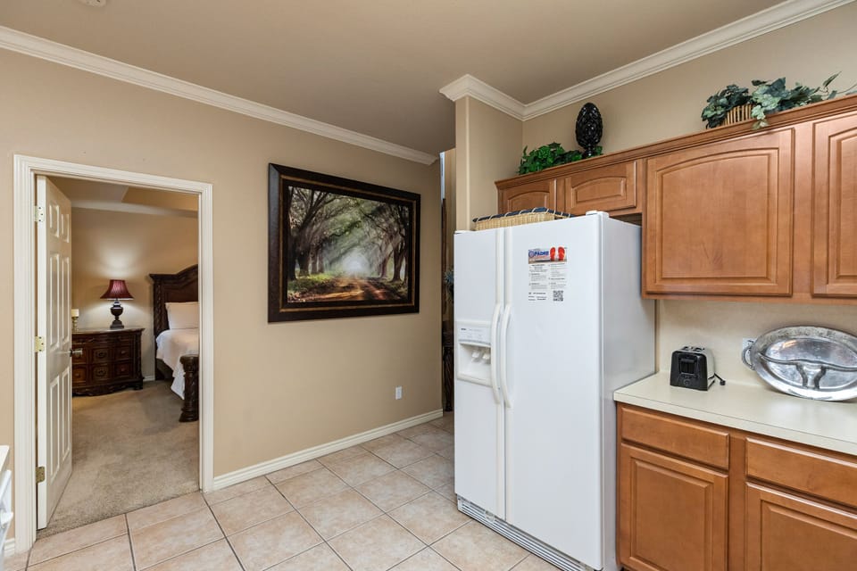 Your kitchen offers warm wood cabinets and modern appliances for preparing home-cooked meals during your stay.