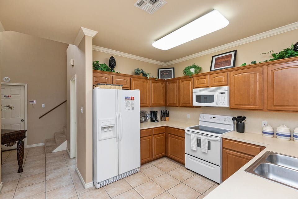 Your fully equipped kitchen awaits with warm wood cabinets, modern appliances, and everything you need to create delicious meals during your stay.