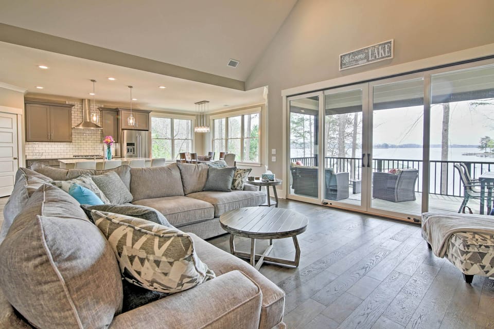 Natural light fills the open living space through the wall of windows.