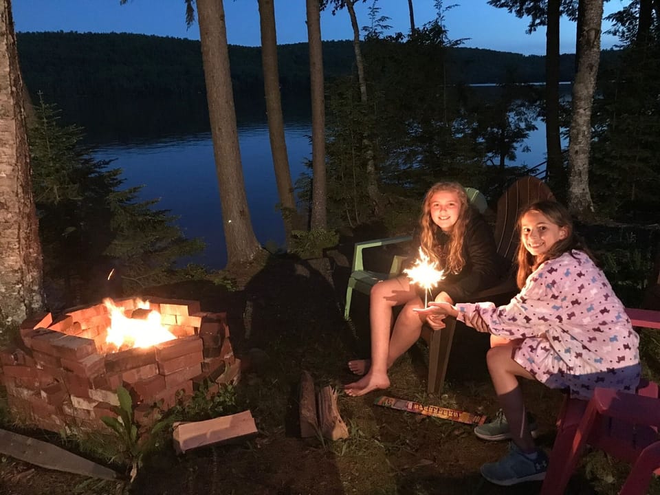 Cousins hanging out roasting marshmallows and calling to the loons!