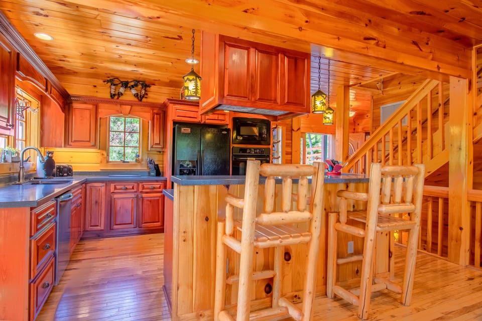 Large kitchen with plenty of counter space, double oven, and seating at bar area
