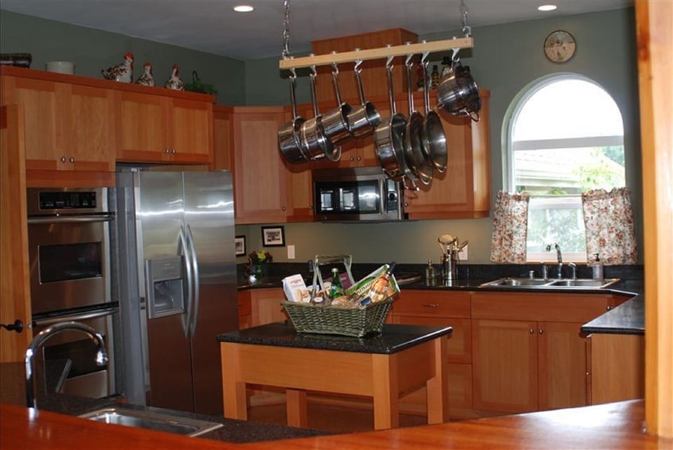 Kitchen with over under double oven, propane cook top, and large microwave oven.