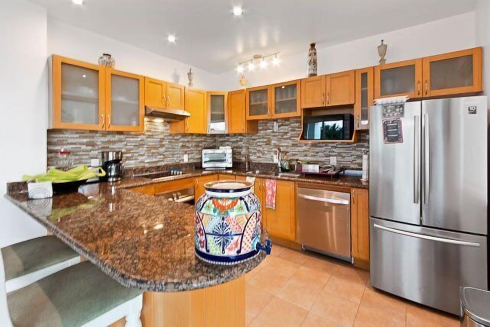 Fully-equipped kitchen with granite counter-tops and stainless steel appliances