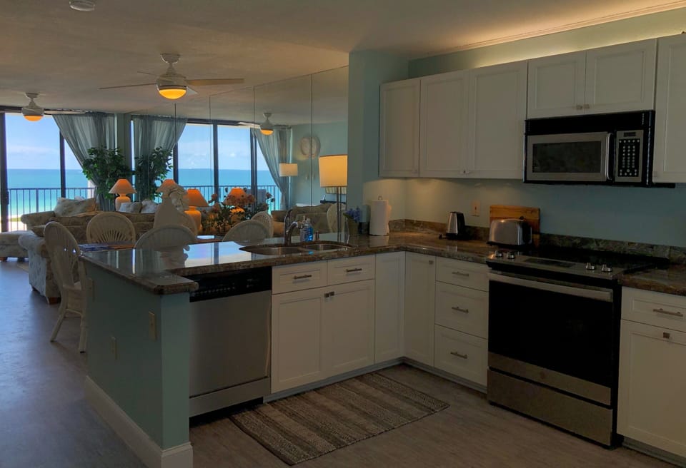 Another view of the beach from this fully equipped kitchen. Perf - Another view of the beach from this fully equipped kitchen. Perfect for making all of your favorite meals while you're here!