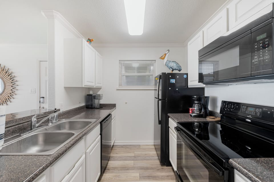 Your fully equipped kitchen awaits with granite countertops, stainless appliances, and everything needed to create memorable meals during your stay.