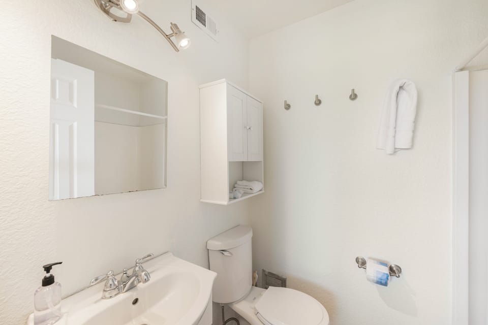 Freshen up in your private bathroom with modern fixtures and thoughtful amenities for a comfortable stay.