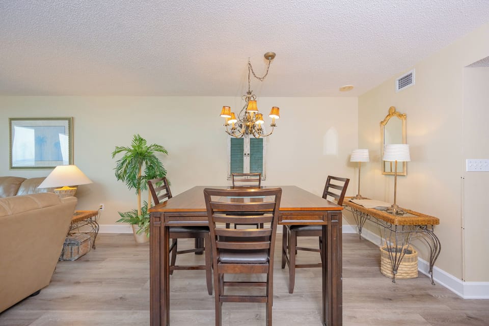 Gather around the stylish dining table, where you can share stories and laughter while enjoying the coastal vibe