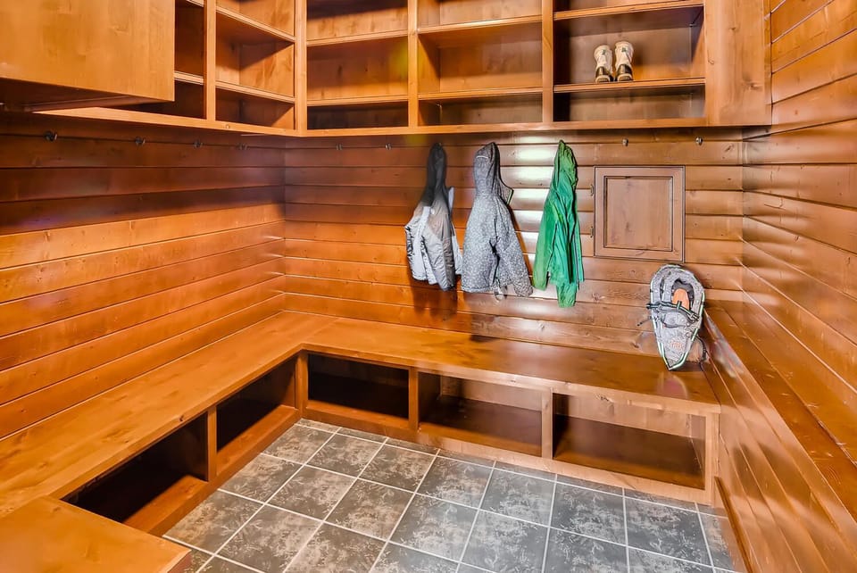 Crestview - Vacation Rental 365 - Downstairs - Spacious mudroom with custom wood cubbies, wall hooks, and built-in bench seating
