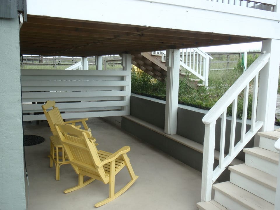 Quaint private patio with views of the backyard and dunes 