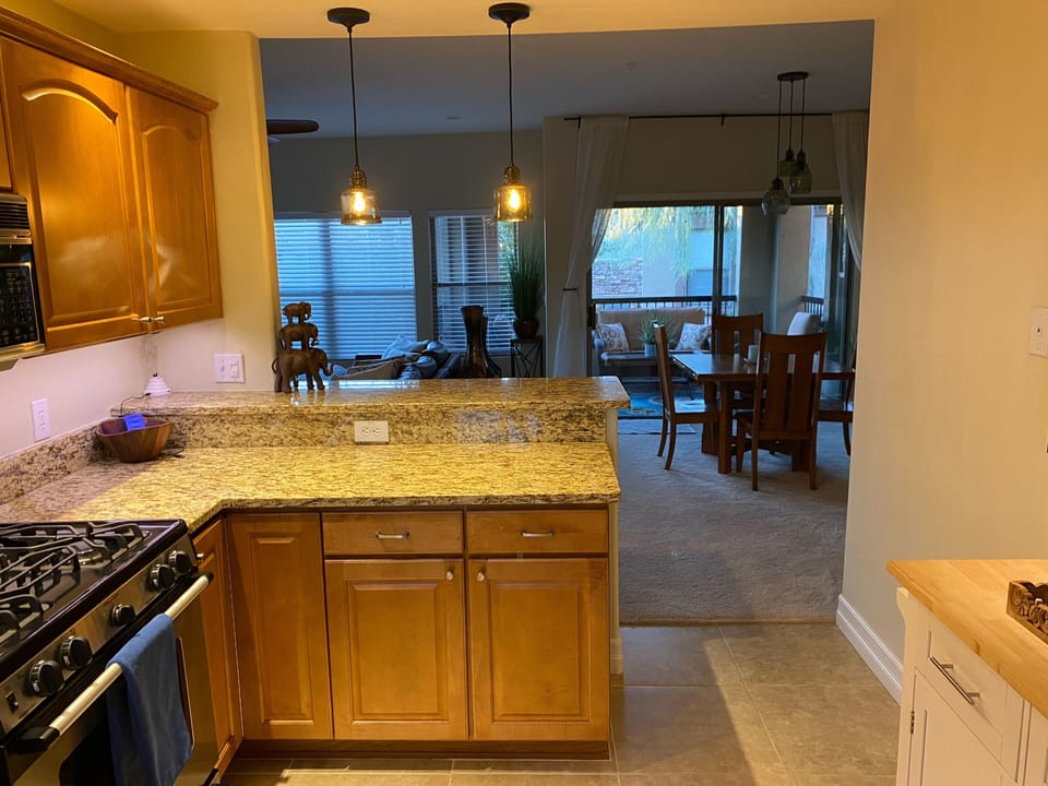 Full serving bar! Opens to Living space! Stone surfaces, Custom tile floors!