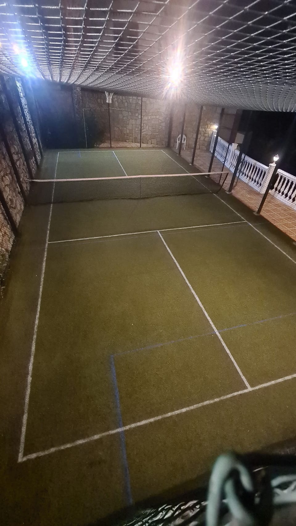 Private sports court in the garden set out as a full sized pickle ball court