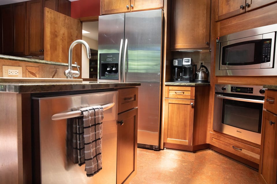 Kitchen with blender, coffee maker, tea pot, toaster oven, and knife set