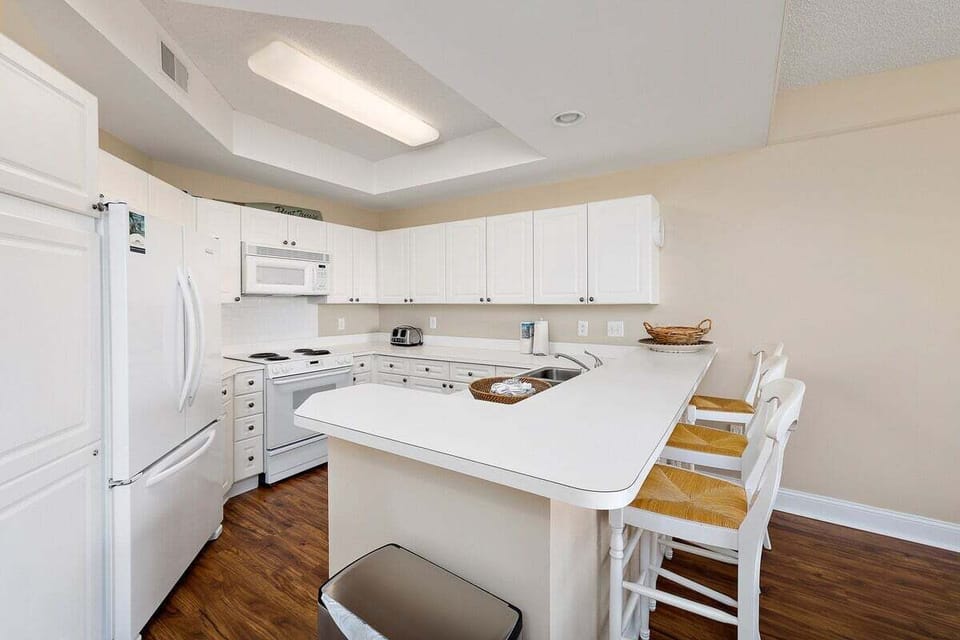 Saint Simons Grand #105 Kitchen with French Door Refrigerator, Electric Stove, and Over-the-Range Microwave