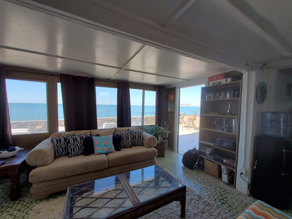 Step outside onto huge sundeck with steps leading right to the beach
