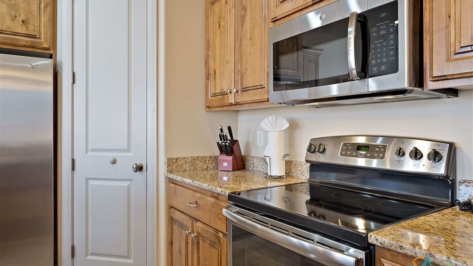 Fully stocked gourmet kitchen featuring top of line stainless steel appliances