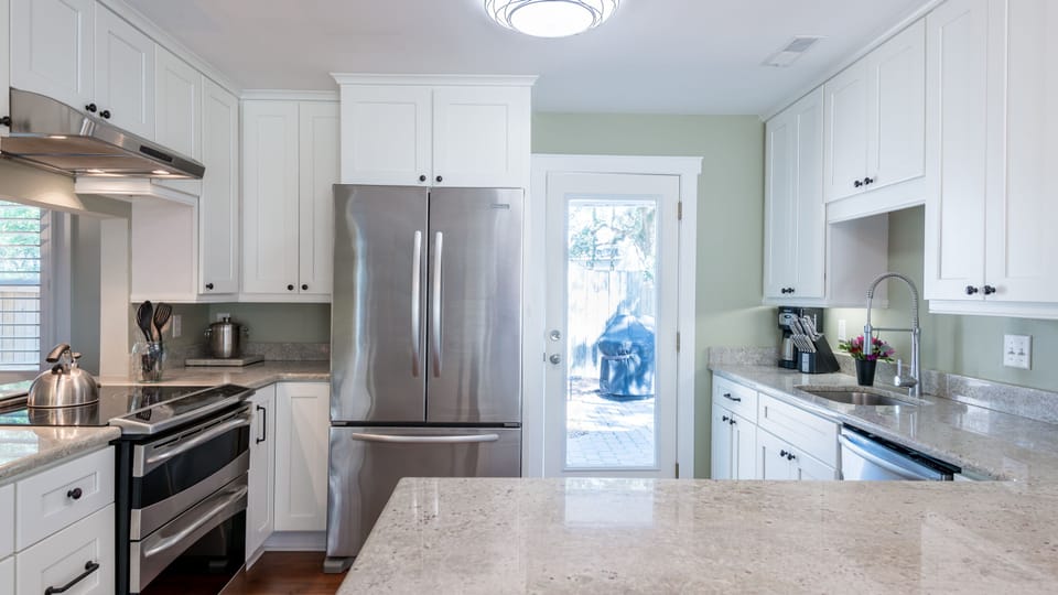 Kitchen leads to back patio, pool and grilling area