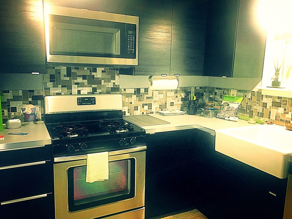 A full classy kitchen of stainless steel appliances.