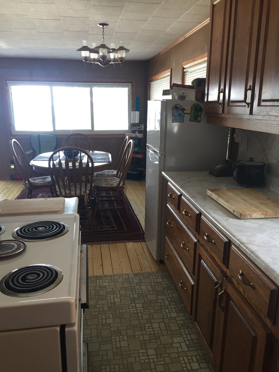 A galley kitchen that is open to the main living space. Equipped with everything you need... the best part of cooking at the cottage is definitely the view.