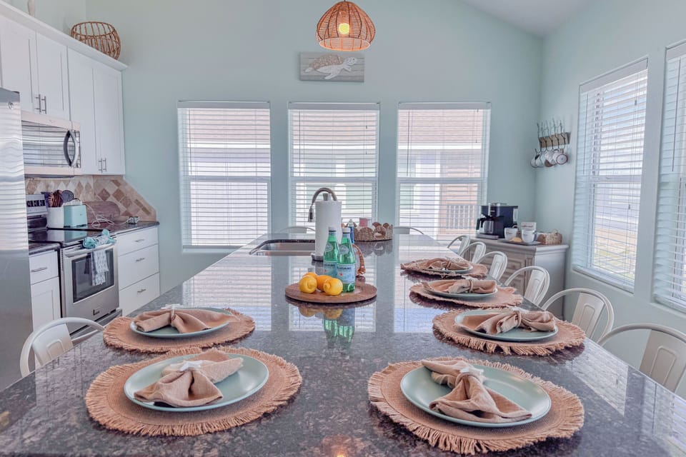 Cook and entertain with ease in this spacious kitchen featuring an eat-at island and ample seating for all.
