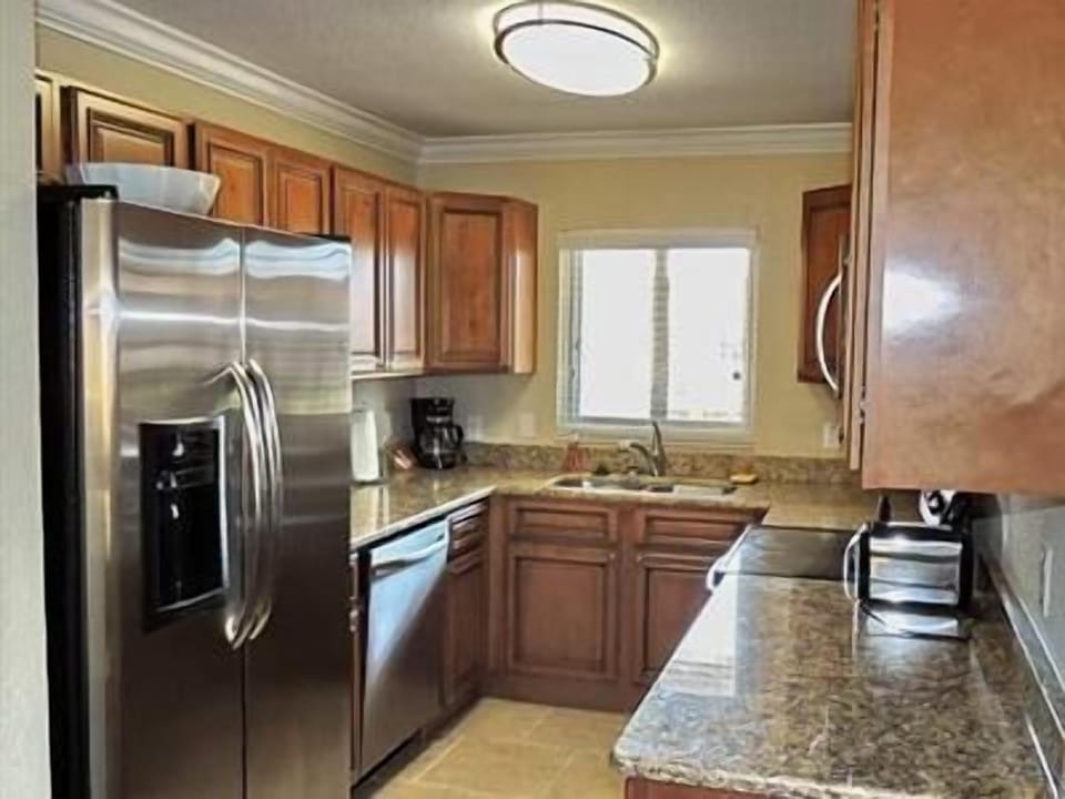 Fully loaded kitchen with granite countertops and stainless steel appliances.