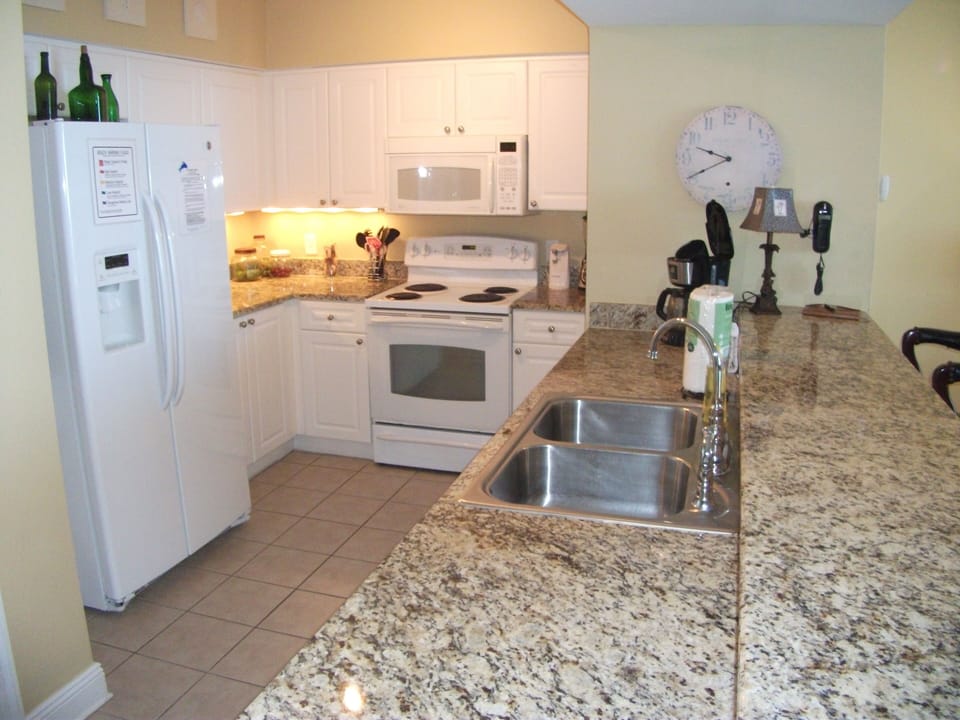 Fully stocked kitchen overlooking the Gulf and open to the living room.
