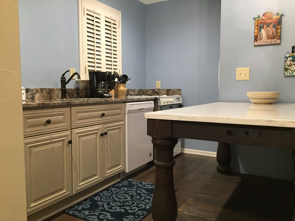 Kitchen with stone countertops. Kuerig coffee maker. 